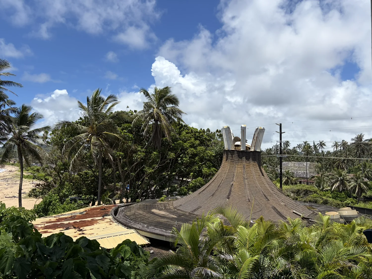 The tent-roofed structure of the former Seashell restaurant at the old Coco Palms Resort, seen from the lanai